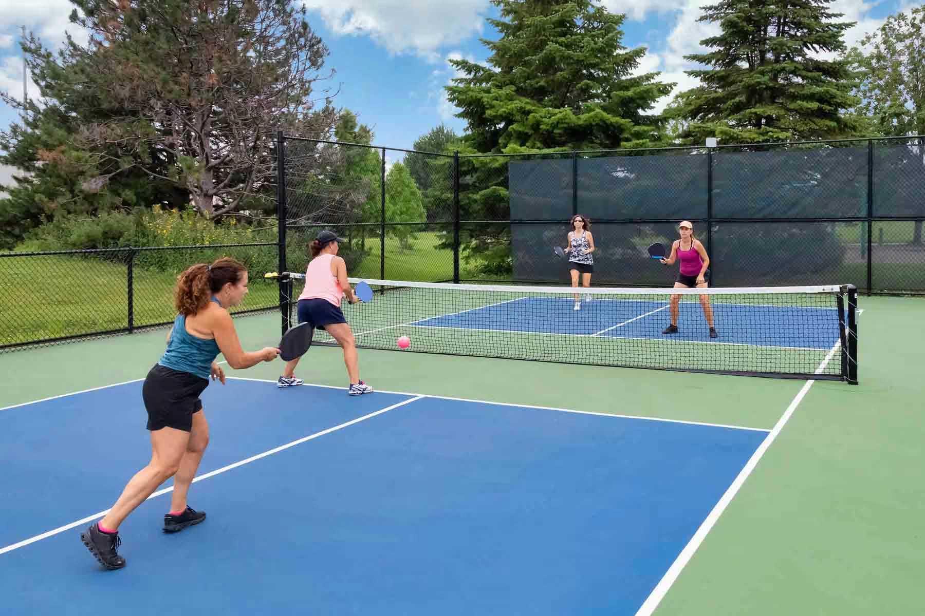 A pickleball machine set up on court, feeding balls for solo practice
